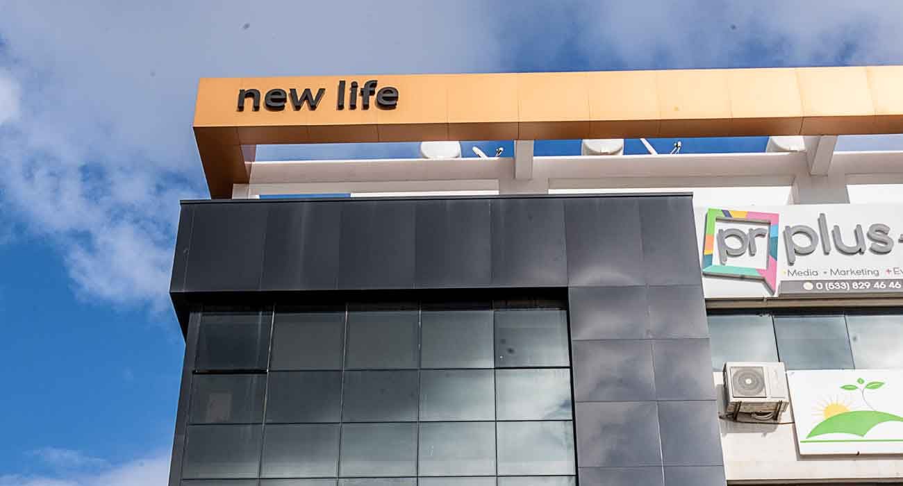 Close view of the New Life copper-coloured top frame and dark glass facade
