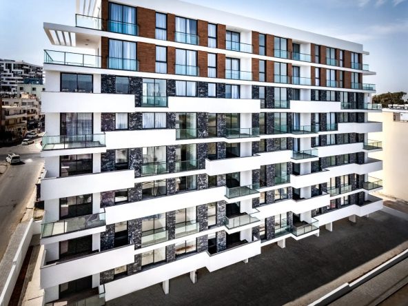 Eight-storey white apartment block with balconies seen from above