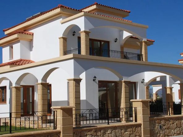 Detached white villa with arched porch and tiled roof at Pearl Village