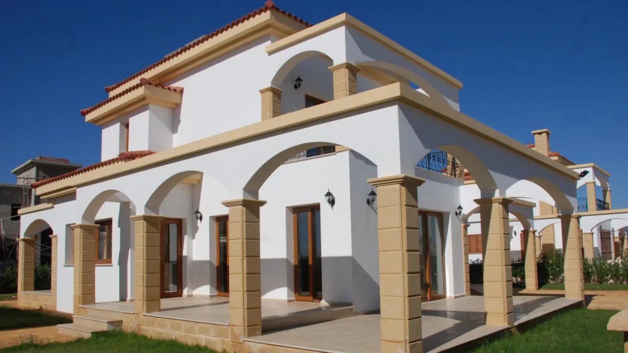 Corner view of a Pearl Village villa with arched terrace and stone columns