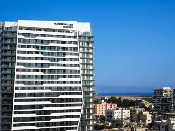 Northernland Premier tower seen above the city rooftops with the sea behind