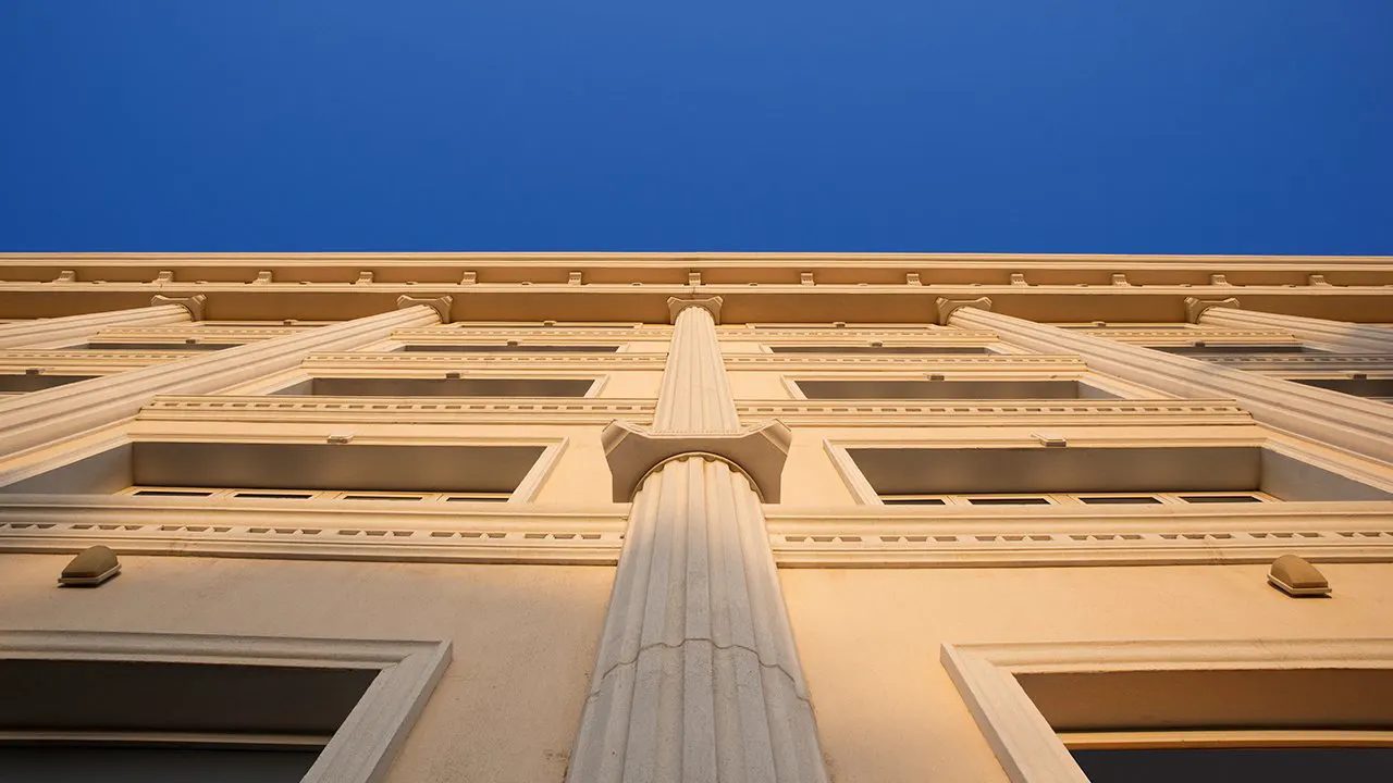 Facade with pilasters and cornice seen from below