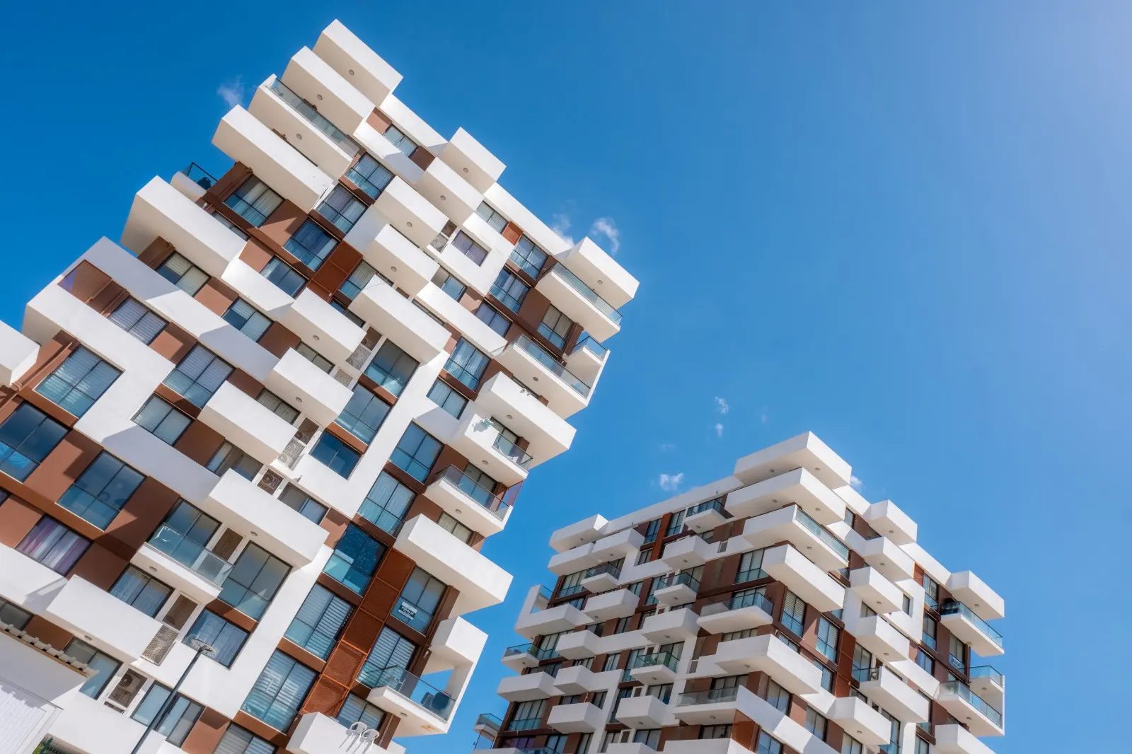 Upward view of the terraced residential blocks against a blue sky