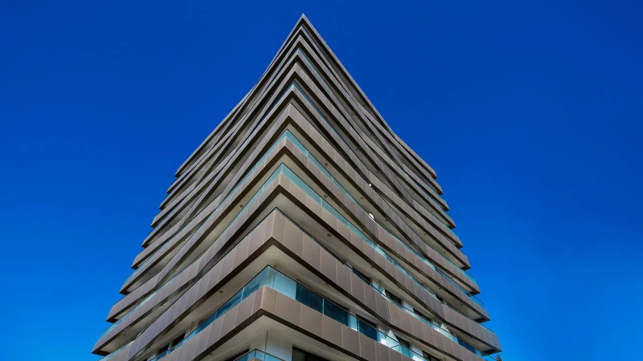 Upward view of the Viapark tower with stepped balcony levels against the sky