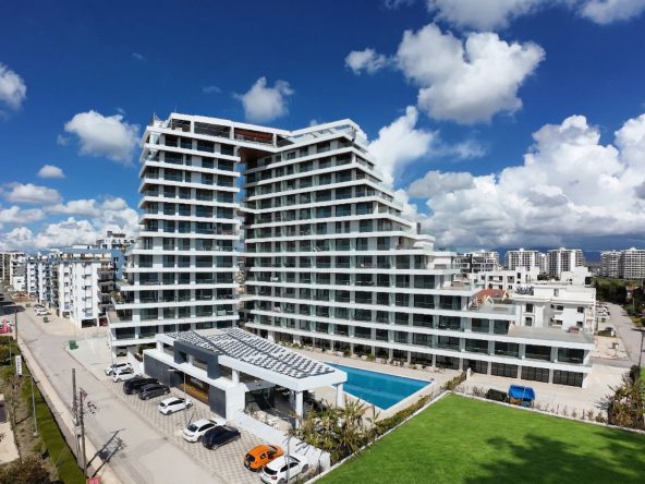 Panorama completed tower with terraced balconies and a pool in front