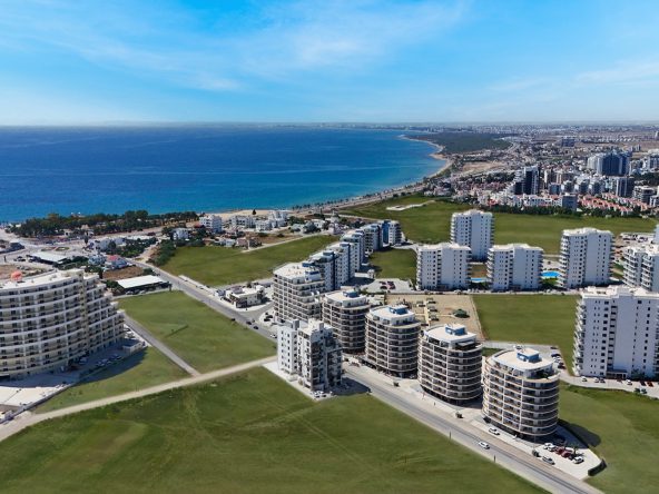 aerial view of Park Residence curved towers with the sea behind