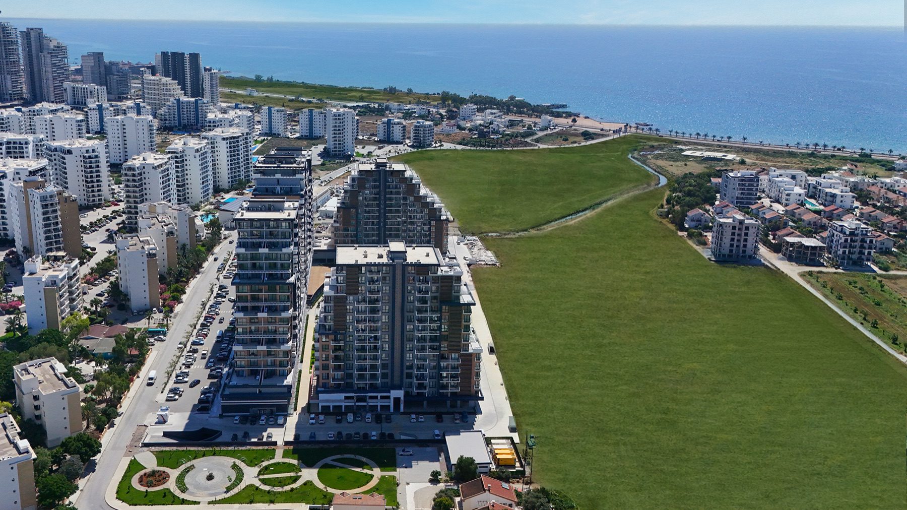 Aerial view of Riverside Life Residence towers, park and coastline