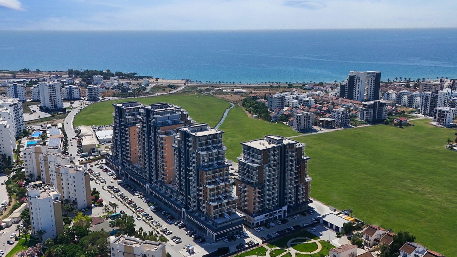 Riverside Life Residence towers seen from the park side with sea behind