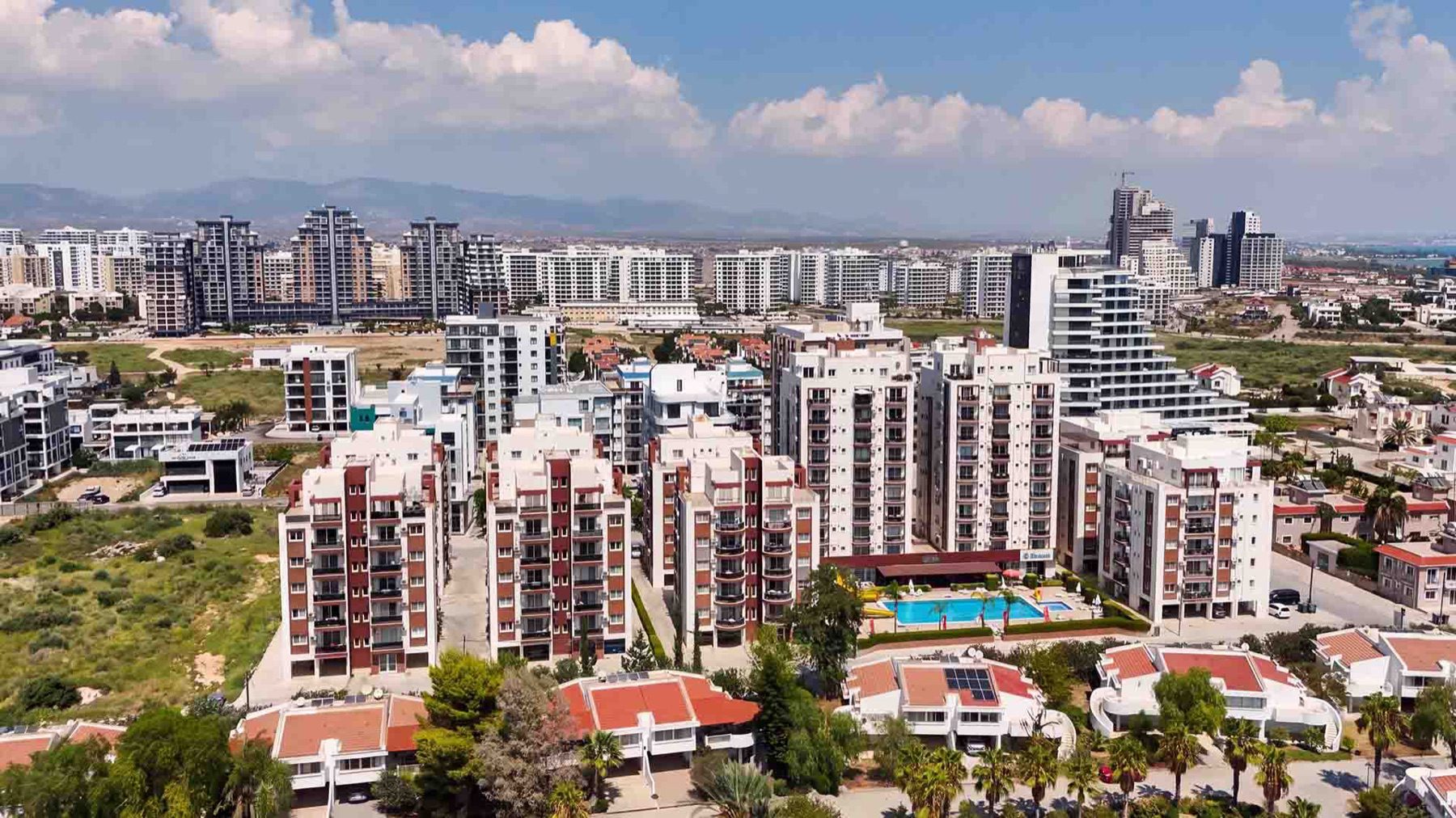Sea Life Plus red and white apartment blocks with pool, aerial view