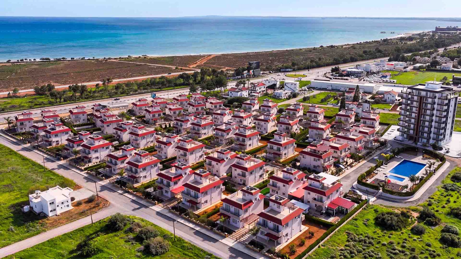 Aerial view of the Sea Pearl Residence villa community and coastline
