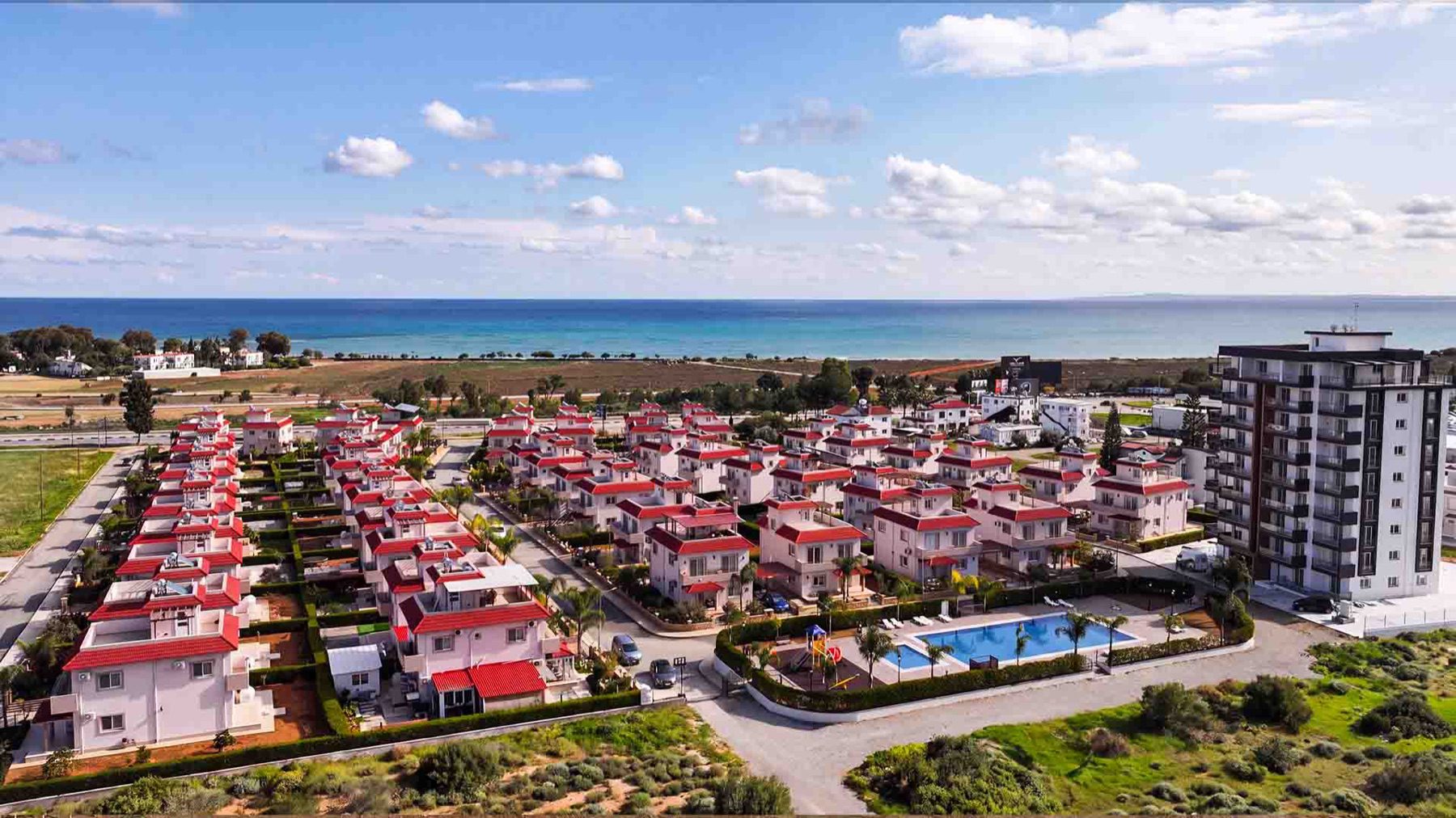 Wide aerial view of Sea Pearl Residence villas with sea horizon