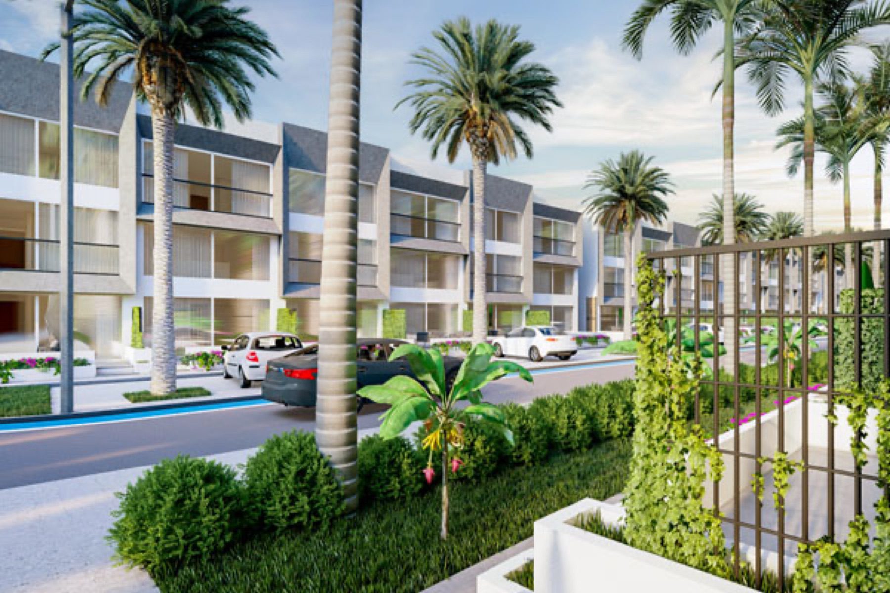 Render of Terra Life buildings seen from a garden fence with palms