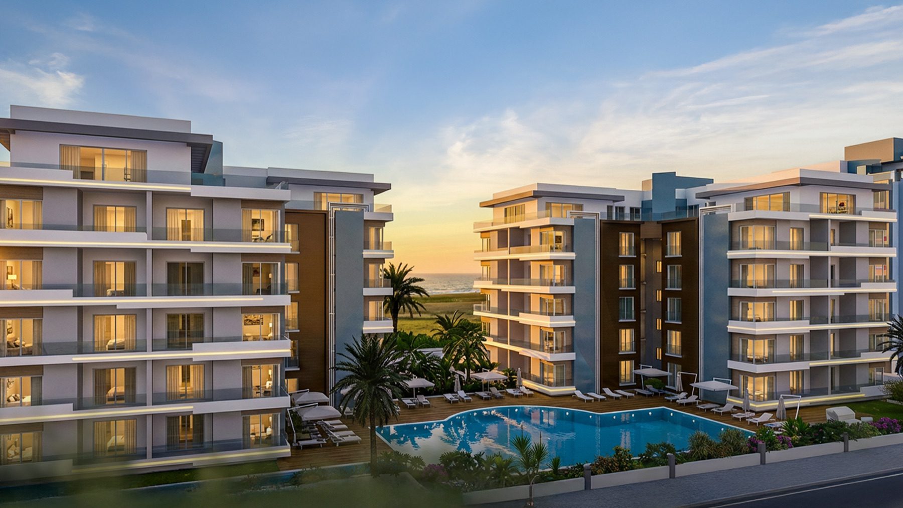 Render of The Blue Residence buildings lit at dusk beside the pool